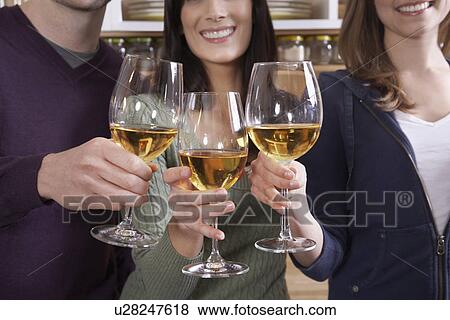 Stock Photo - Three Mid-Adults Toasting with Wine. Fotosearch