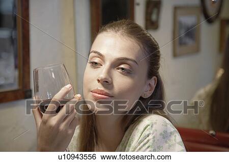 Young woman drinking red wine (portrait) View Large Photo Image Stock Photograph - Young woman drinking red wine (portrait). Fotosearch