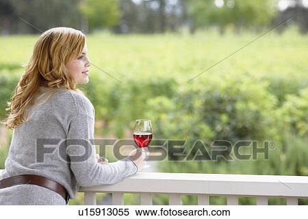 Stock Photography - Young woman drinking red wine. Fotosearch