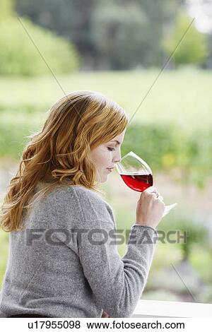 Young woman smelling red wine View Large Photo Image Stock Photo - Young woman smelling red wine. Fotosearch
