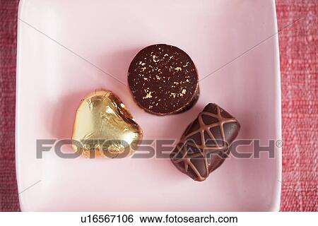 Stock Photograph - Chocolates on plate (close-up, directly above). Fotosearch