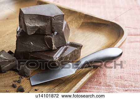 Dark chocolate pieces on tray View Large Photo Image Stock Image - Dark chocolate pieces on tray. Fotosearch