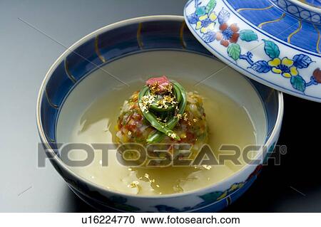 Stock Image - Japanese steamed food in a bowl, high angle view, close up, black background, Japan. Fotosearch