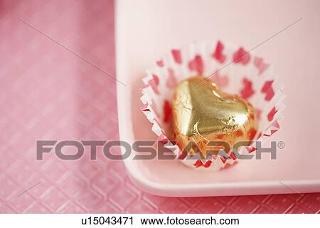 Stock Image - Single chocolate on plate (close-up). Fotosearch