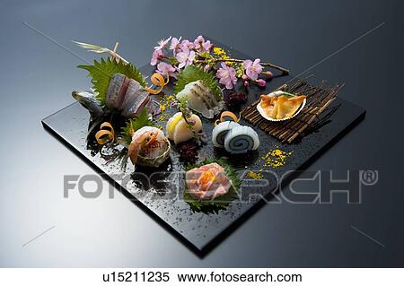 Sliced raw fishes on a tray, high angle view, black background, Japan View Large Photo Image Stock Photography - Sliced raw fishes on a tray, high angle view, black background, Japan. Fotosearch