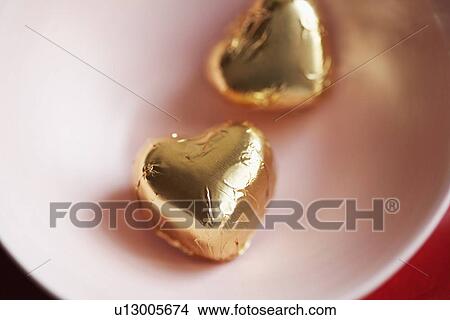 Picture - Two heart shaped candies in bowl (close-up, directly above). Fotosearch