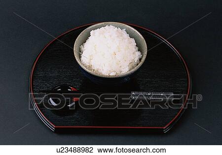 Stock Image - Bowl Of Rice With Chopsticks. Fotosearch