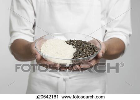 Chef holding bowl of white and wild rice (mid section) View Large Photo Image Stock Image - Chef holding bowl of white and wild rice (mid section). Fotosearch