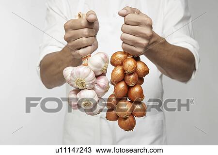 Chef holding bunch of garlic and shallot onions (mid section) View Large Photo Image Stock Image - Chef holding bunch of garlic and shallot onions (mid section). Fotosearch