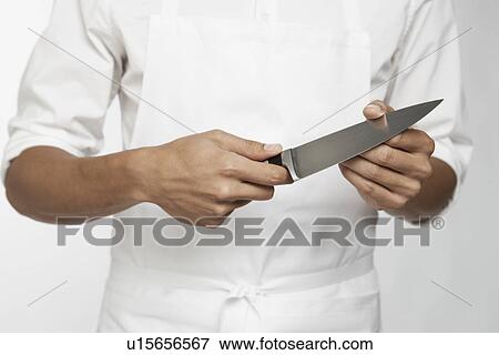 Chef holding kitchen knife (mid section) View Large Photo Image Stock Photo - Chef holding kitchen knife (mid section). Fotosearch