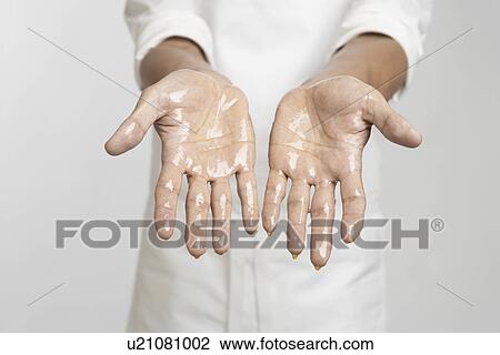 Stock Image - Chef's hands in oil (close-up). Fotosearch