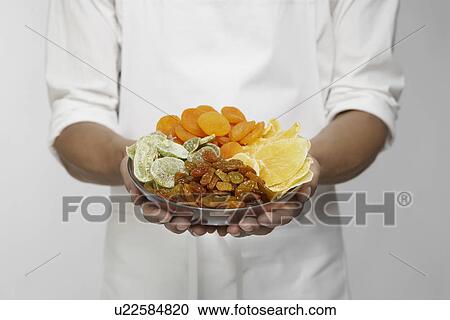 Selection of dried fruits on chef's hands (mid section) View Large Photo Image Stock Image - Selection of dried fruits on chef's hands (mid section). Fotosearch