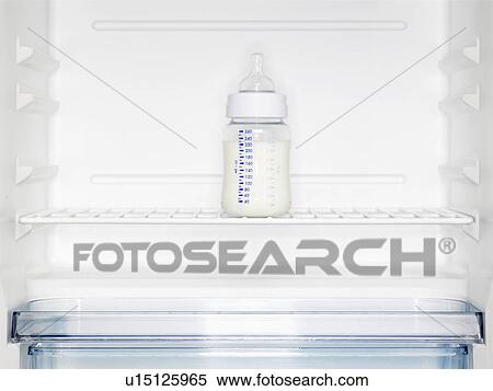 Baby's milk bottle in fridge (close-up) View Large Photo Image Stock Photography - Baby's milk bottle in fridge (close-up). Fotosearch
