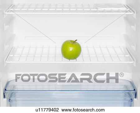Stock Image - Green apple in fridge (close-up). Fotosearch