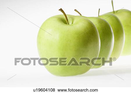 Stock Photo - Green apples in row. Fotosearch