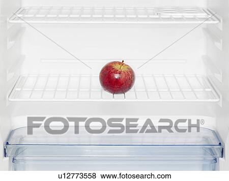 Stock Photo - Red apple in fridge (close-up). Fotosearch