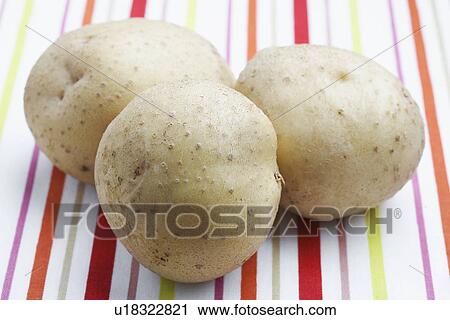 Three potatoes on tablecloth View Large Photo Image Stock Image - Three potatoes on tablecloth. Fotosearch