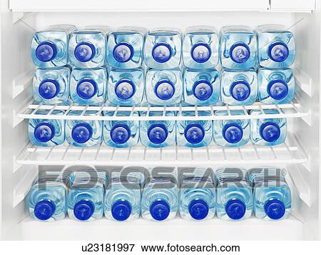 Stock Photo - Water bottles in fridge. Fotosearch