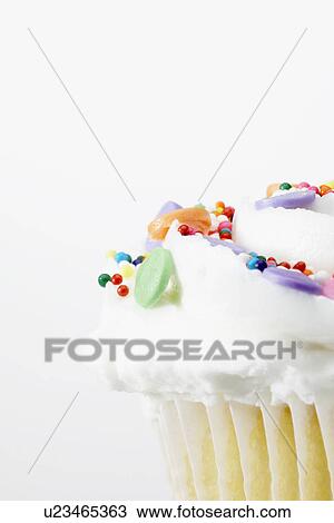 Stock Image - Cake with colorful sprinkles (close-up). Fotosearch