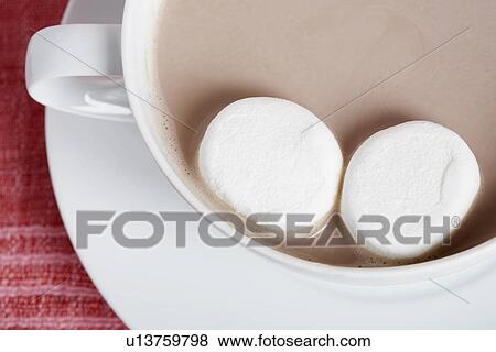 Stock Photo - Candies in cappuccino (close-up, directly above). Fotosearch