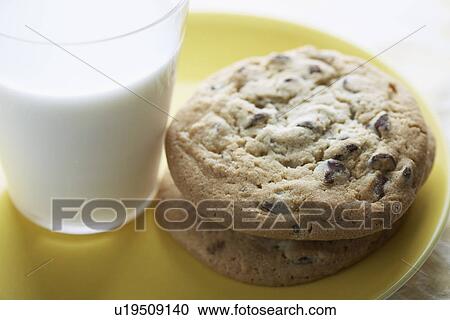 Chocolate chip cookies beside glass of milk (close-up) View Large Photo Image Stock Image - Chocolate chip cookies beside glass of milk (close-up). Fotosearch