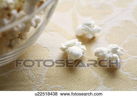 Stock Photo - Close-up of popcorn near bowl. Fotosearch