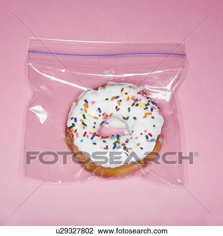 Stock Image - Doughnut in Plastic Bag. Fotosearch