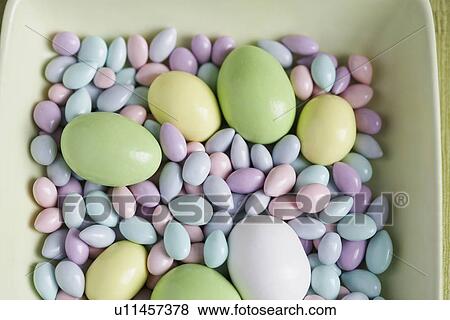 Stock Photo - Easter eggs and candies in bowl (close-up, high angle view). Fotosearch