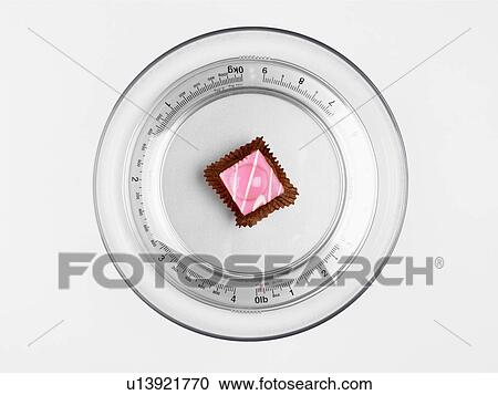 Single cake on bathroom scale (close-up, directly above) View Large Photo Image Stock Image - Single cake on bathroom scale (close-up, directly above). Fotosearch