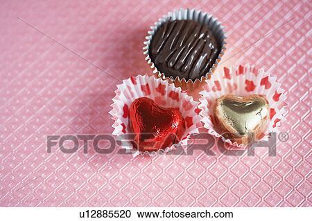 Stock Image - Three chocolates (close-up). Fotosearch