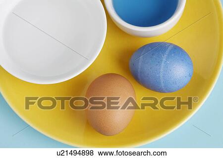 Two eggs by Easter egg dye (close-up, directly above) View Large Photo Image Stock Photo - Two eggs by Easter egg dye (close-up, directly above). Fotosearch