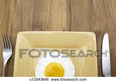 Fried egg on plate (close-up, directly above) View Large Photo Image Stock Photograph - Fried egg on plate (close-up, directly above). Fotosearch