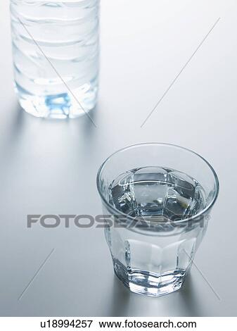 Glass of Water near Bottle View Large Photo Image Stock Photo - Glass of Water near Bottle. Fotosearch