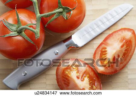 Stock Photo - Knife and tomatoes. Fotosearch