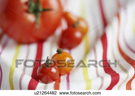 Tomatoes on tablecloth (close-up) View Large Photo Image Stock Image - Tomatoes on tablecloth (close-up). Fotosearch