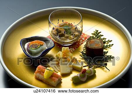 Stock Photograph - Various Japanese food on a plate, high angle view, black background, Japan. Fotosearch