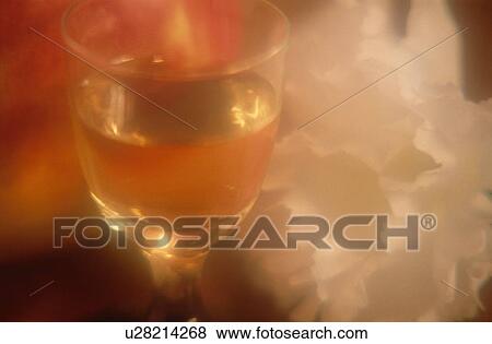 Stock Photo - Glass Of Wine Near Flower. Fotosearch