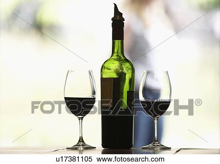 Stock Photography - Two glasses of red wine and bottle. Fotosearch