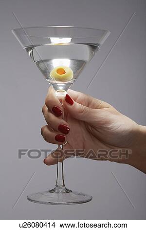 Picture - Woman's hand holding martini cocktail (close-up). Fotosearch