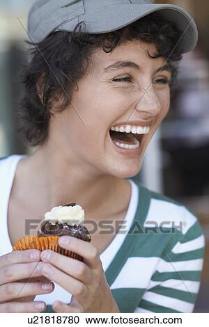 Teenage girl laughing and eating cake View Large Photo Image Stock Image - Teenage girl laughing and eating cake. Fotosearch