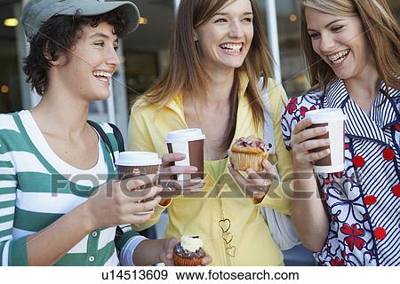 Three teenage girls drinking take-out coffees and eating cakes View Large Photo Image Stock Photo - Three teenage girls drinking take-out coffees and eating cakes. Fotosearch