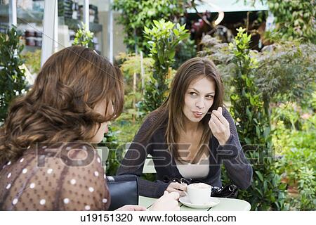 Two women drinking coffee View Large Photo Image Stock Image - Two women drinking coffee. Fotosearch