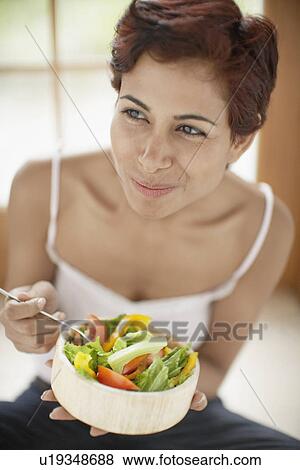 Stock Photo - Woman eating salad (high angle view). Fotosearch