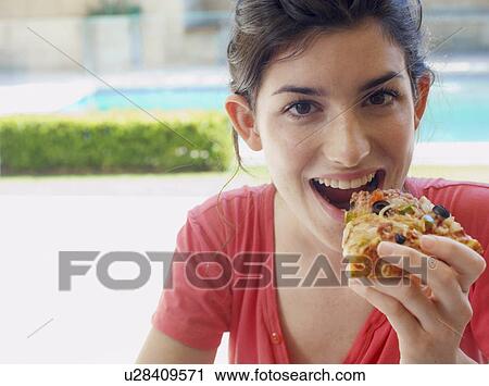 Young woman eating pizza View Large Photo Image Stock Image - Young woman eating pizza. Fotosearch