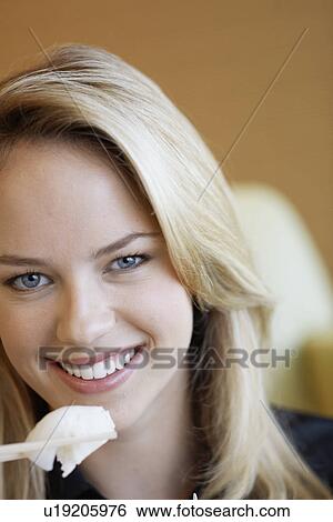 Young woman eating with chopsticks View Large Photo Image Stock Photograph - Young woman eating with chopsticks. Fotosearch