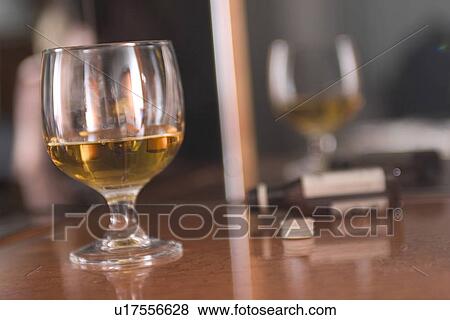 Stock Photo - bottle, reflective, table, clear, liquor, alcohol. Fotosearch