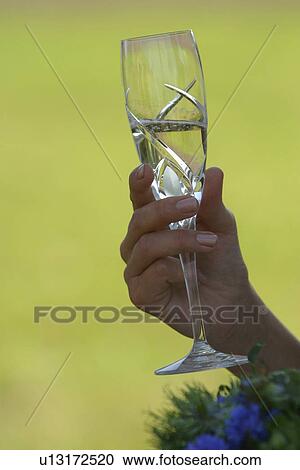 Stock Image - wine, holding, toast, hand, drinking, glass. Fotosearch