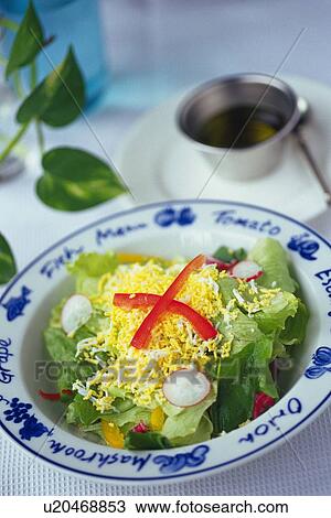 Stock Image - Caesar salad on plate with salad dressing, Differential Focus. Fotosearch