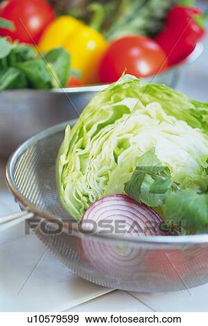Halves of cabbage and red onion in bowl, paprika and leaf vegetables in bowl visible in background, Differential Focus, close up View Large Photo Image Stock Photo - Halves of cabbage and red onion in bowl, paprika and leaf vegetables in bowl visible in background, Differential Focus, close up. Fotosearch