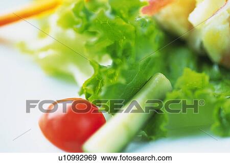 Stock Photo - Mixed salad leaves on plate, Differential Focus, Close Up. Fotosearch
